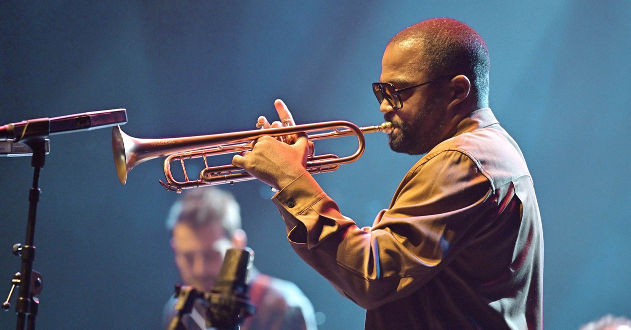 Ludovic Louis performing live, playing trumpet on stage